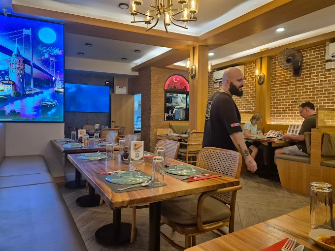 Restaurant dining area with wooden tables and warm lighting